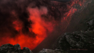 Red glow rising from the active crater of Masaya Volcano after sunset, Nicaragua
